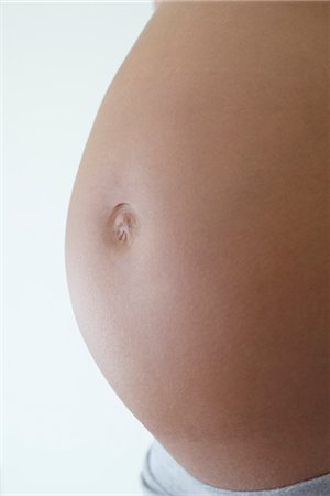 Close-up of woman's pregnant belly Stock Photo - Premium Royalty-Free, Code: 632-05554221