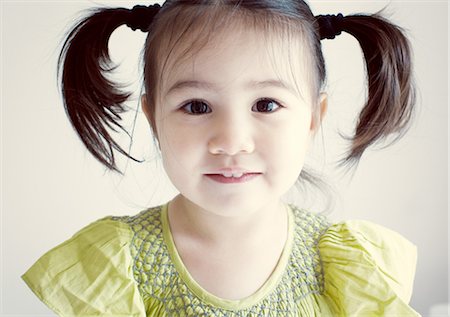 Little girl with pigtails, portrait Fotografie stock - Premium Royalty-Free, Codice: 632-05553400