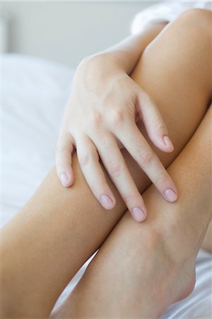 simsearch:632-05844991,k - Woman's hand touching legs Stock Photo - Premium Royalty-Free, Code: 632-05553414