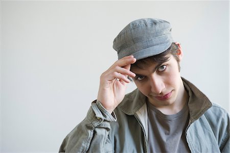 frontal view head down - Male tipping hat to camera, portrait Stock Photo - Premium Royalty-Free, Code: 632-05553463