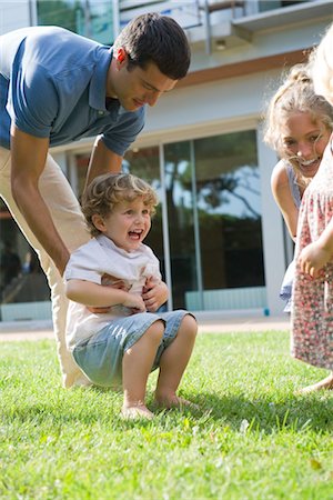 family on lawn - Family having fun together outdoors Stock Photo - Premium Royalty-Free, Code: 632-05553530