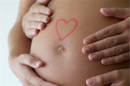 simsearch:632-05554036,k - Couple's hands on woman's pregnant belly Foto de stock - Sin royalties Premium, Código: 632-05553624