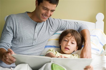 reading on bed - Father and son reading story together Stock Photo - Premium Royalty-Free, Code: 632-05553729