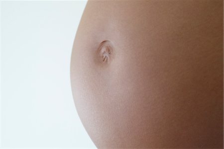 Close-up of woman's pregnant belly Foto de stock - Sin royalties Premium, Código: 632-05553776