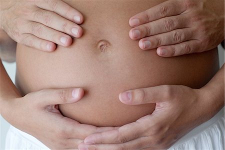 parto - Couple's hands on woman's pregnant belly Foto de stock - Sin royalties Premium, Código: 632-05553784