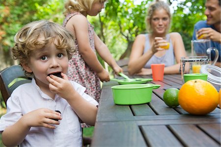 picnic table - Boy enjoying outdoor snack with his family Stock Photo - Premium Royalty-Free, Code: 632-05553829