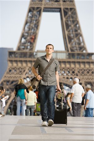 Male tourist walking with luggage, Eiffel Tower, Paris, France Stock Photo - Premium Royalty-Free, Code: 632-05553821