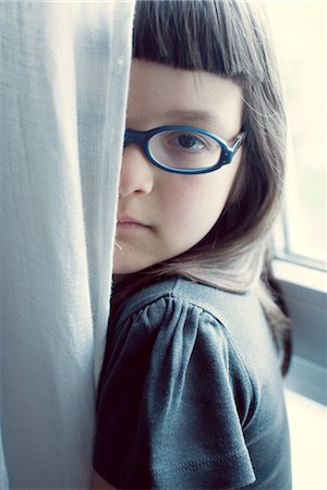 Girl hiding behind curtain Stock Photo - Premium Royalty-Free, Code: 632-05553920