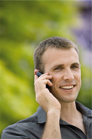 Man using cell phone outdoors Stock Photo - Premium Royalty-Free, Code: 632-05553973