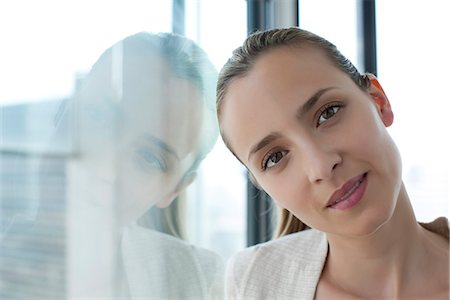 Woman leaning against window, head tilted Stock Photo - Premium Royalty-Free, Code: 632-05604003