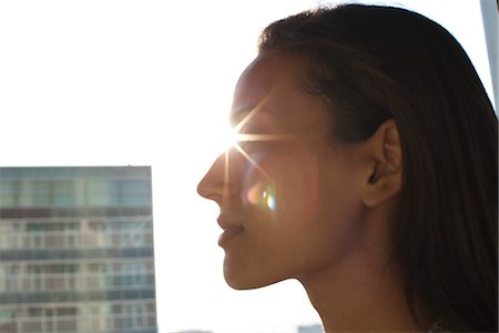 future image - Silhouette of woman's face, sun shinning in background Stock Photo - Premium Royalty-Free, Code: 632-05604193