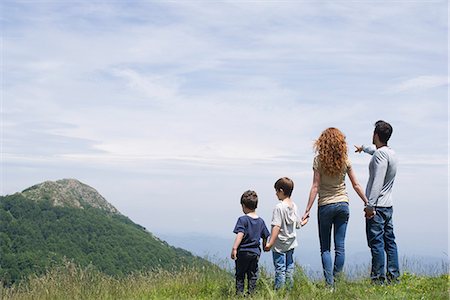 family standing back rear view - Family enjoying scenic mountain view, rear view Stock Photo - Premium Royalty-Free, Code: 632-05604333