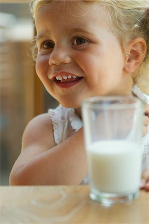 Little girl enjoying glass of milk Stock Photo - Premium Royalty-Free, Code: 632-05604376