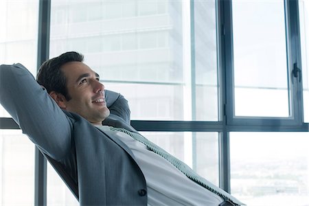 single loaf - Business executive relaxing with hands behind head Stock Photo - Premium Royalty-Free, Code: 632-05604387