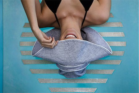 fashion photography swimming pool - Woman reclining poolside, concealing face with brim of sun hat Stock Photo - Premium Royalty-Free, Code: 632-05604476