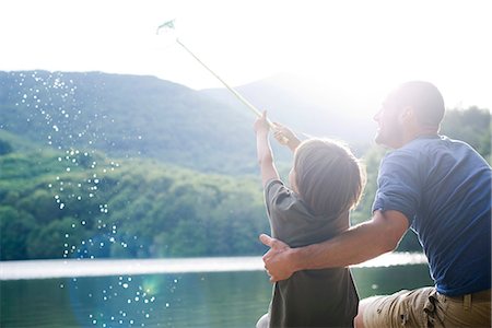 pond - Father and son fishing, boy caught fish in fishing net Stock Photo - Premium Royalty-Free, Code: 632-05604527