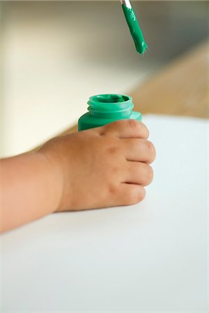 Child dipping paintbrush into paint, cropped Stock Photo - Premium Royalty-Free, Code: 632-05604600