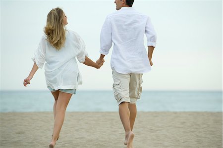 people walking rear view - Couple walking hand in hand on beach, rear view Stock Photo - Premium Royalty-Free, Code: 632-05603813