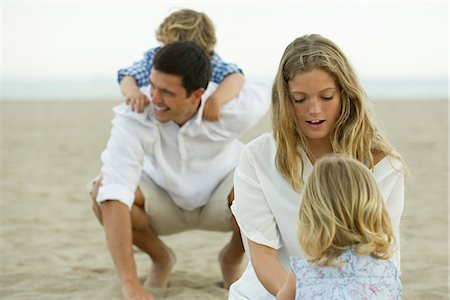 piggyback ride mom kid - Family playing together at the beach Stock Photo - Premium Royalty-Free, Code: 632-05603838