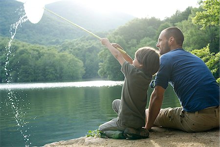 fishing and family - Father and son fishing, boy holding up fishing net Stock Photo - Premium Royalty-Free, Code: 632-05603944