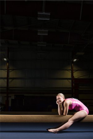 simsearch:632-05816164,k - Female gymnast sitting on balance beam Foto de stock - Sin royalties Premium, Código: 632-05759535