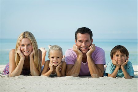 family relaxing with kids in the sun - Family lying on sand at the beach, portrait Stock Photo - Premium Royalty-Free, Code: 632-05759548