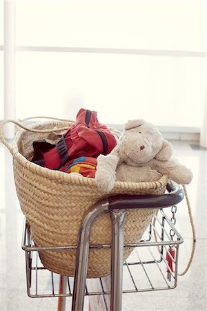 Child's teddy bear and other belongings in basket Stock Photo - Premium Royalty-Free, Code: 632-05759672