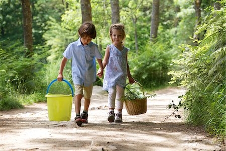 Children walking hand in hand in woods, carrying basket and bucket Stock Photo - Premium Royalty-Free, Code: 632-05759716