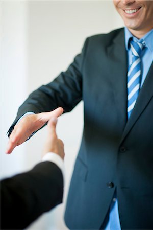 Executives extending hands to shake, cropped Stock Photo - Premium Royalty-Free, Code: 632-05759810