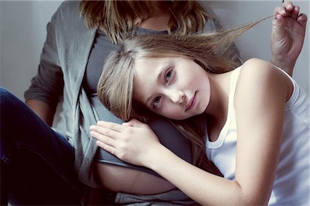 preteen girl and tank top - Girl listening to mother's abdomen Stock Photo - Premium Royalty-Free, Code: 632-05759835