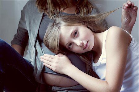 preteen tanktop - Girl listening to mother's abdomen Stock Photo - Premium Royalty-Free, Code: 632-05759835