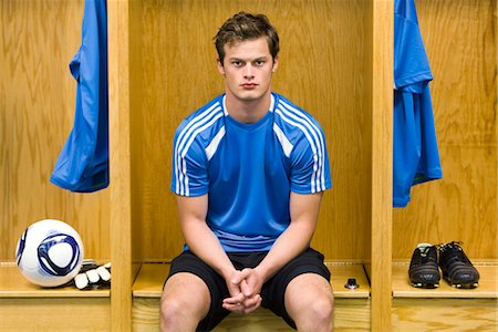 football locker room photography - Young soccer player sitting in locker room, portrait Stock Photo - Premium Royalty-Free, Code: 632-05759838