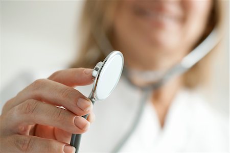 doctor examine woman only - Doctor holding out stethoscope, cropped Stock Photo - Premium Royalty-Free, Code: 632-05759867