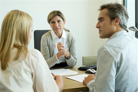 services bank - Businesswoman talking with clients in office Stock Photo - Premium Royalty-Free, Code: 632-05759878