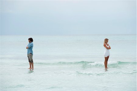 quarrel couple - Couple standing apart in sea with backs turned toward each other Stock Photo - Premium Royalty-Free, Code: 632-05759940