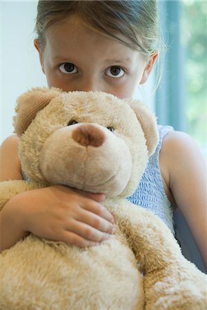 shy children - Little girl hugging teddy bear Stock Photo - Premium Royalty-Free, Code: 632-05760017