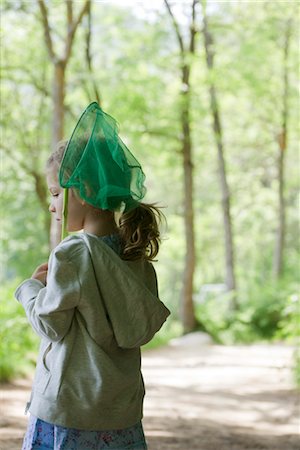 simsearch:632-03652319,k - Girl carrying butterfly net in woods Fotografie stock - Premium Royalty-Free, Codice: 632-05760072