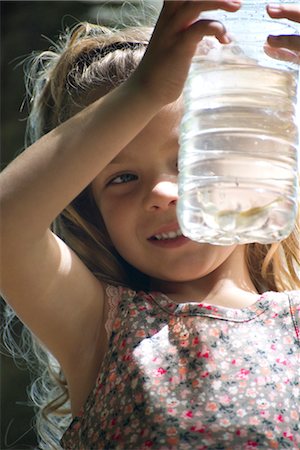 simsearch:632-05759978,k - Girl looking at bottle of water Stock Photo - Premium Royalty-Free, Code: 632-05760112