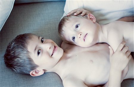 siblings lying - Little boy resting head on older brother's chest, portrait Stock Photo - Premium Royalty-Free, Code: 632-05760124