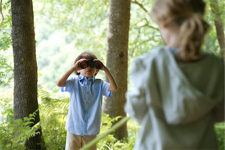 Children in woods, boy looking through binoculars Stock Photo - Premium Royalty-Free, Code: 632-05760126