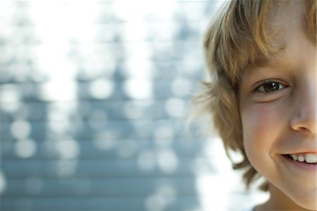 simsearch:632-05844982,k - Boy smiling at camera, cropped portrait Stock Photo - Premium Royalty-Free, Code: 632-05760173