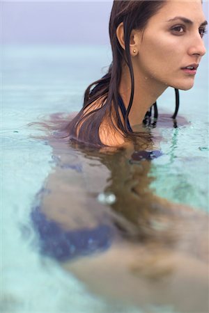 Woman in water, looking away in thought Stock Photo - Premium Royalty-Free, Code: 632-05760191