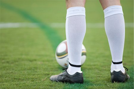 soccer player (male) - Soccer player standing on field, low section Stock Photo - Premium Royalty-Free, Code: 632-05760193