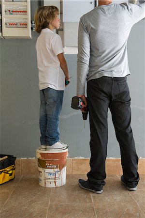 electrical panel - Boy watching father doing home improvement Stock Photo - Premium Royalty-Free, Code: 632-05760230