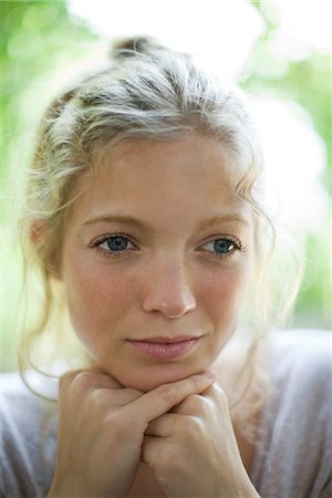 sad woman thinking - Woman resting chin on hands, looking away in thought, portrait Stock Photo - Premium Royalty-Free, Code: 632-05760396