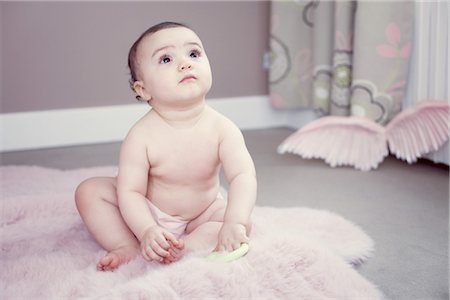 diaper girl - Baby sitting on rug, portrait Stock Photo - Premium Royalty-Free, Code: 632-05760410