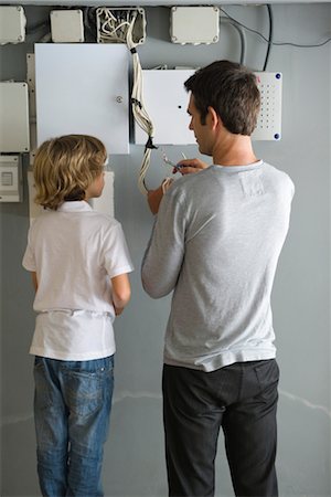 dad not mom child back - Son watching father fixing wires Stock Photo - Premium Royalty-Free, Code: 632-05760474