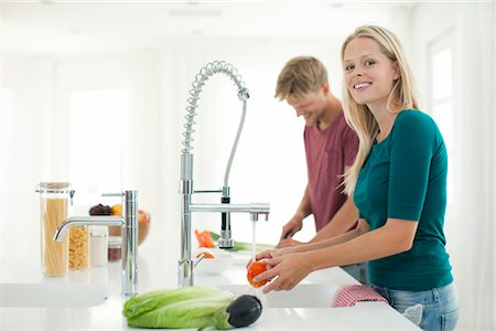 Couple preparing meal together in kitchen Stock Photo - Premium Royalty-Free, Code: 632-05760551