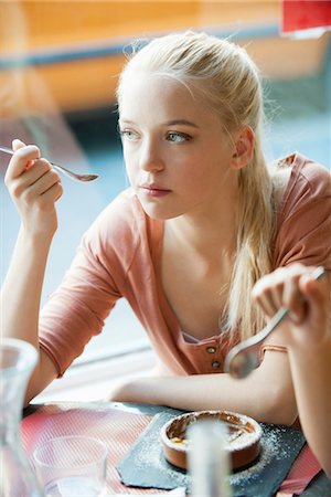 dessert, restaurant - Young woman eating dessert Stock Photo - Premium Royalty-Free, Code: 632-05760574