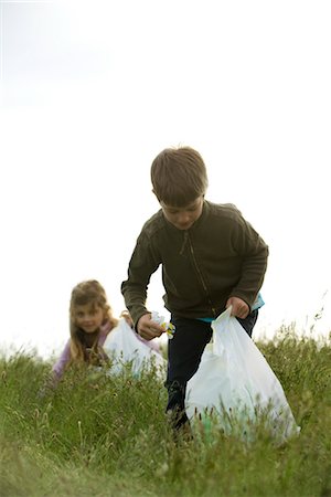 picking up - Children picking up trash in field Stock Photo - Premium Royalty-Free, Code: 632-05760629